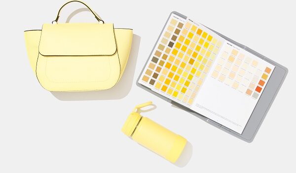 Yellow handbag and container with pantone book for colour selection